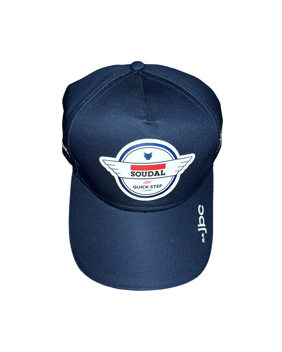 A navy blue baseball cap featuring a prominent white, red, and blue Soudal Quick-Step logo patch on the front, with a white vertical JBC logo on the side of the brim, shown against a plain white background.